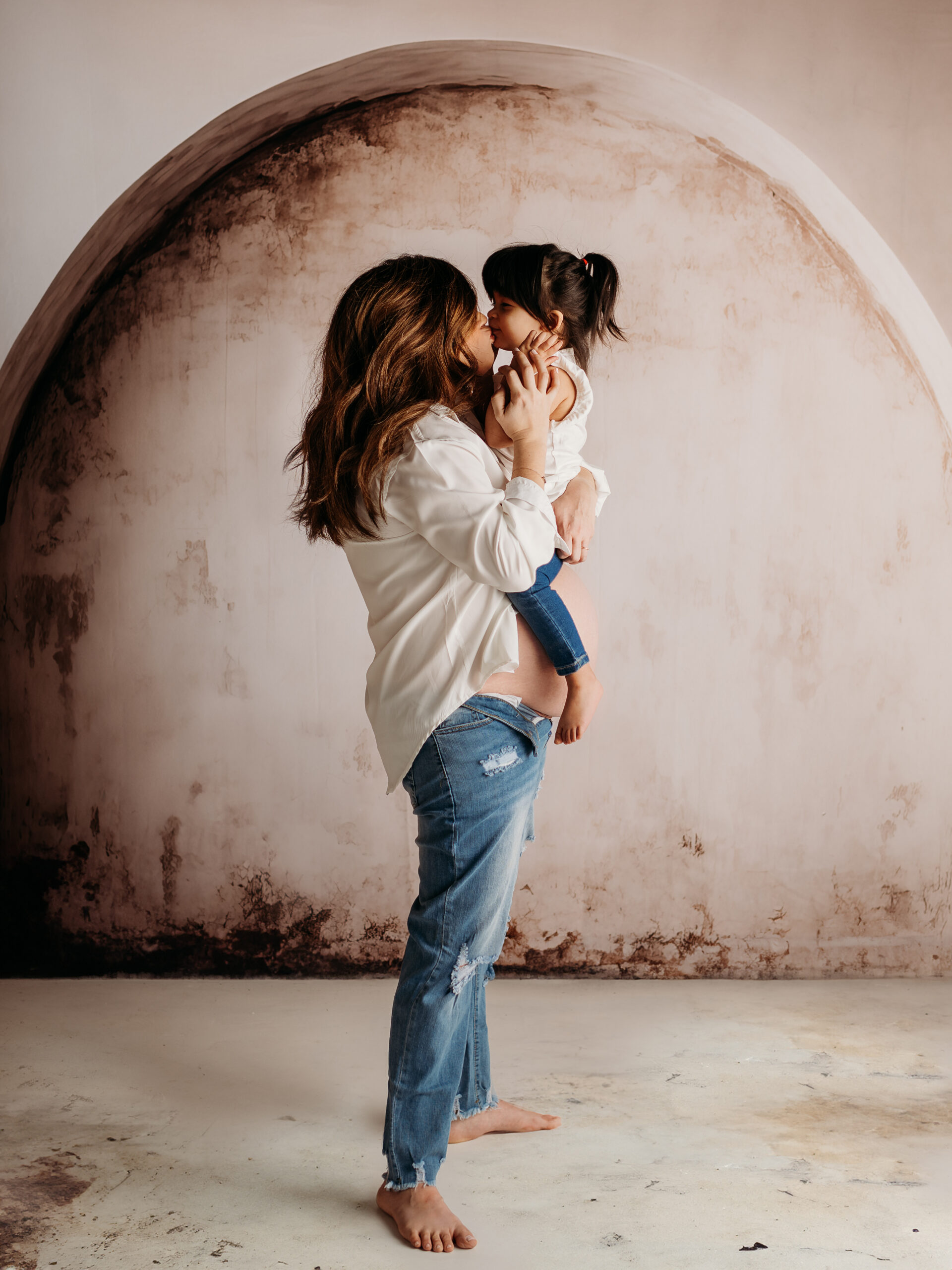 Pregnant woman and husband posing together during studio maternity session near Palatine IL — Kiley Humbert Photography